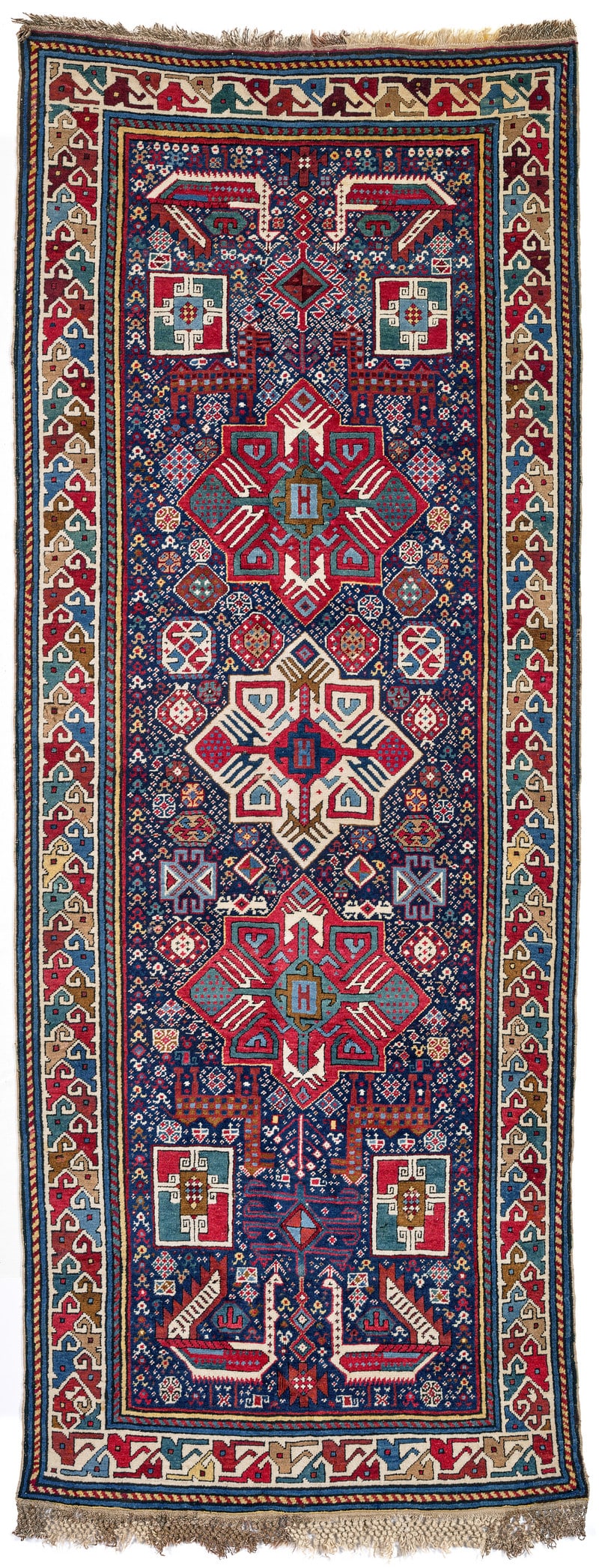 Akstafa: second half 19th century, 272 x 104 cm, East Caucasus, Shirvan The three large octagrams aligned on the central axis of the midnight blue field each contain an animal-tree-motif. The field ground is d