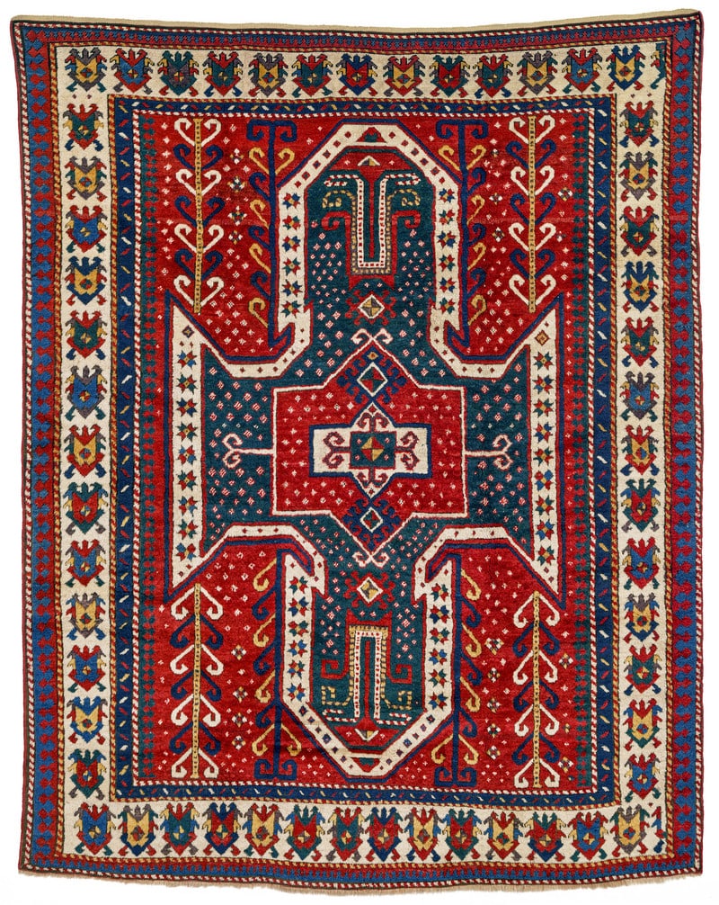 Sevan Kazak: second half 19th century, 230 x 184 cm, South West Caucasus A large green shield medallion, its wide white outline studded with stars, fills the whole of the red field. A red cartouche lies at its