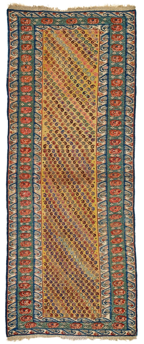 Zeikhur Sumakh: mid 19th century, 224 x 93 cm, East Caucasus The golden yellow field is covered in a repeat of tiny angular botehs arranged into steep colour diagonals. An alternative reading shows offset horizontal