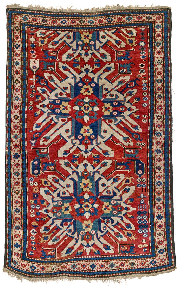 Chelaberd: late 19th century, 240 x 153 cm, South Caucasus, Karabagh The red field is taken up by two large sunburst medallions, accompanied by small blossoms and a number of decorative motifs along the sides.