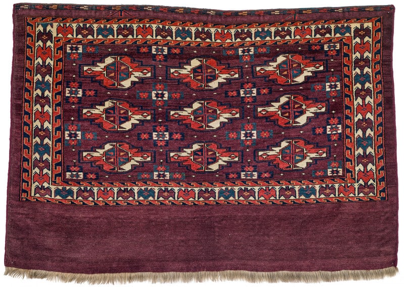Yomut Chuval: mid 19th century, 79 x 115 cm, Central Asia, West Turkestan A Yomut bag face presenting nine primary guls and straight-armed cruciform secondary guls, butterfly motifs in the white main border and
