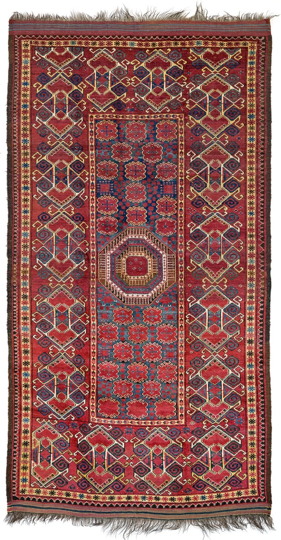 Beshir: second half 19th century, 256 x 137 cm, Central Asia, middle Amu Darya valley At the centre of the narrow blue-green field, a large octagonal gul resembling an ornamental plate is surrounded by red bl