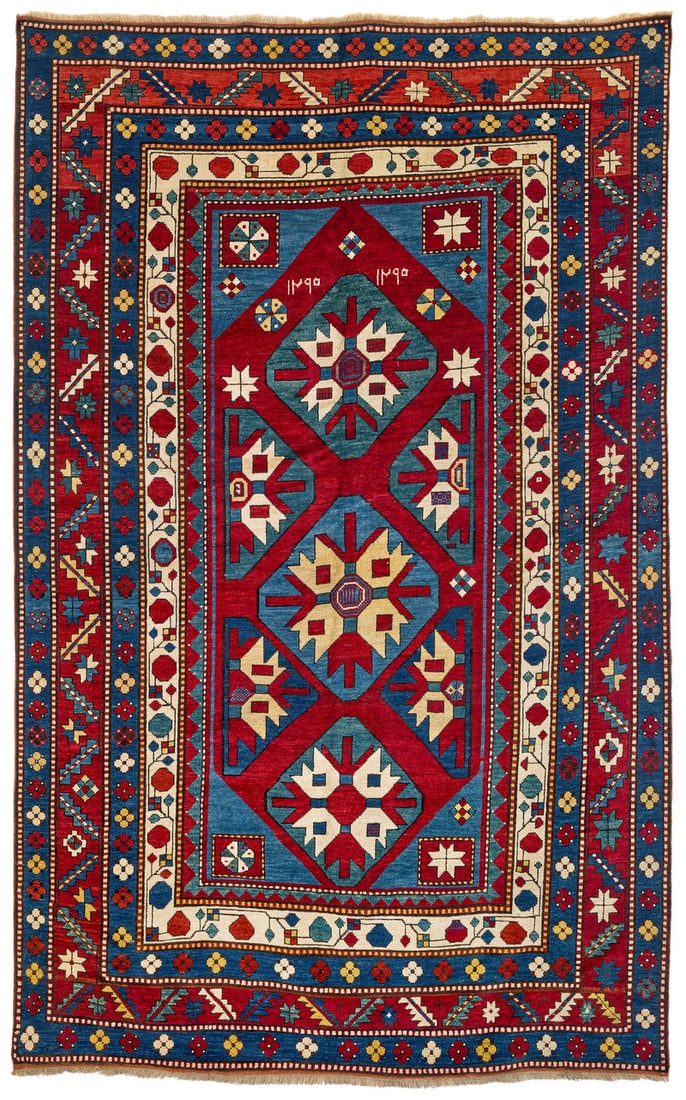 Lambalo Kazak: dated 1295 = 1878, 254 x 159 cm, South West Caucasus Three hexagons enclosing a large star are aligned on the central axis of the red field. Four halved analogous motifs are placed at the sides. The