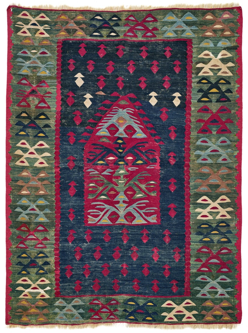 Sarkoy Prayer Kilim: second half 19th century, 140 x 104 cm, South East Europe, Bulgaria The dark blue field shows a design of red and four white, mushroom-shaped devices placed in offset rows. A small house-like prayer