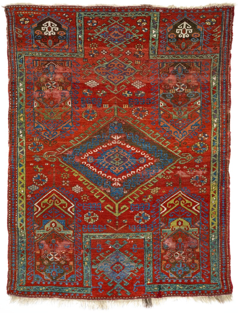 Konya Prayer Rug: 17th / 18th century, 179 x 136 cm, Central Anatolia An early prayer rug presenting a re-entrant design. A large diamond with hooked outlines lies at the centre of the red field, surrounded by four