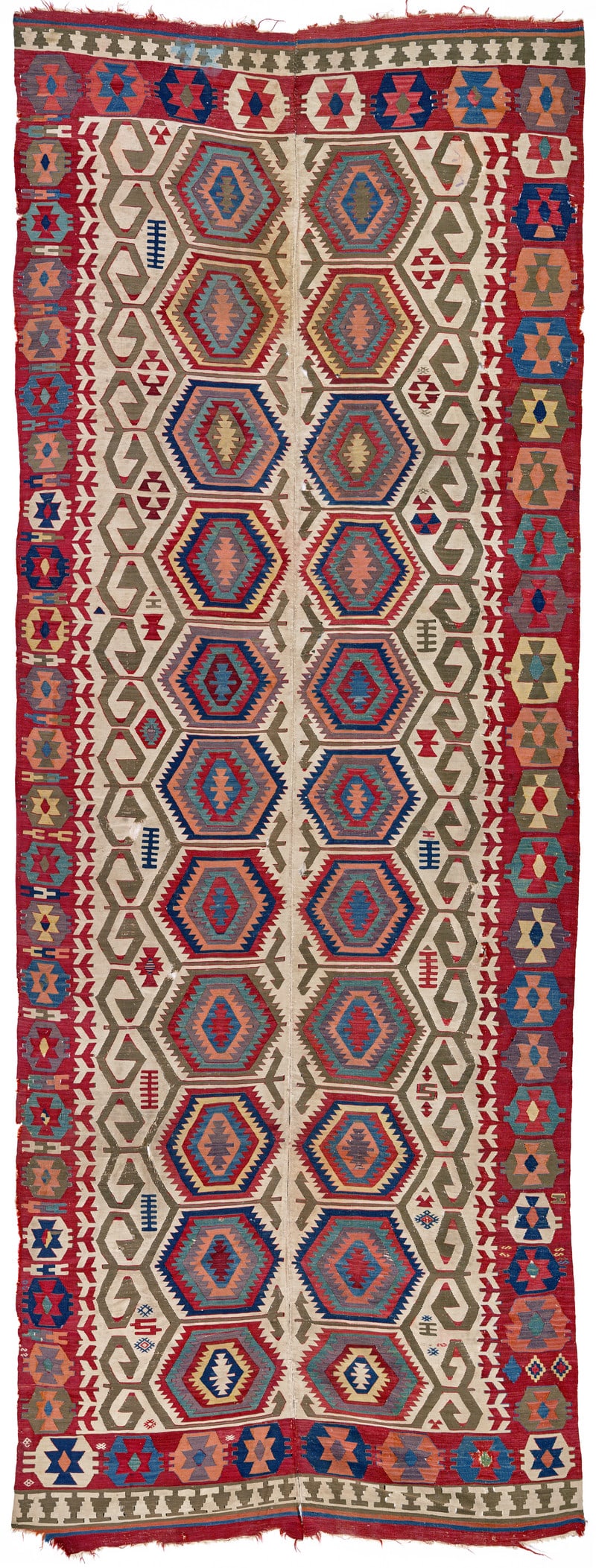 Konya Kilim: ca. 1800, 439 x 169 cm, Central Anatolia A two-panel kilim framed by a burgundy main border. The entire design is simply drawn, focussing on essentials. Nested hexagons in diverse colours with