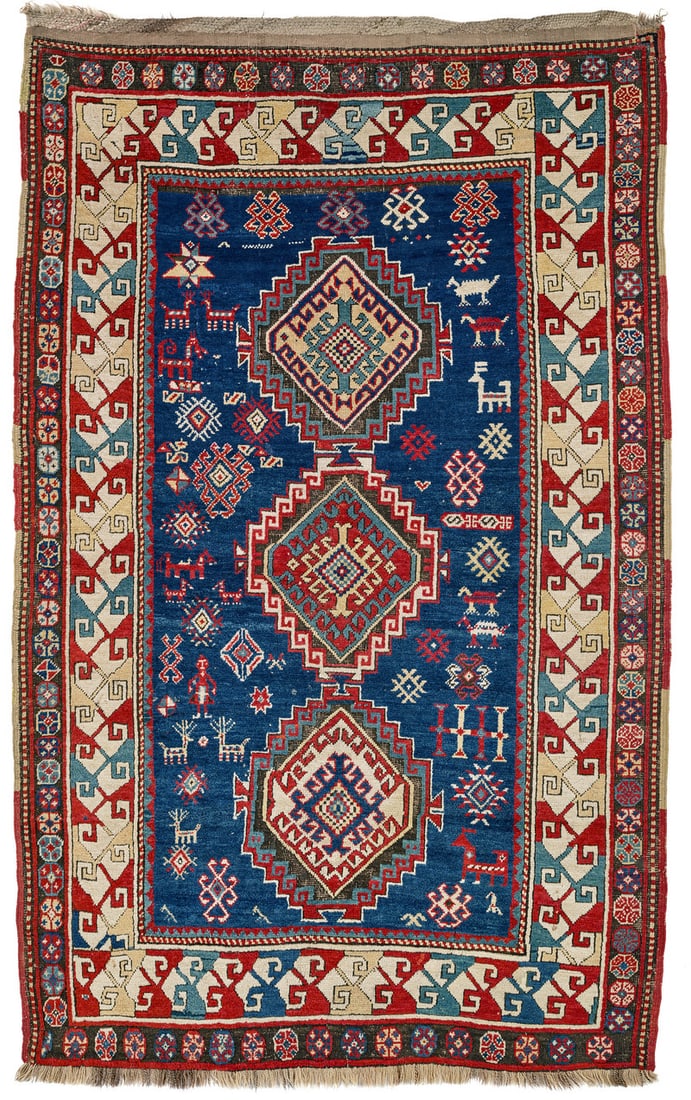 Daghestan: mid 19th century, 217 x 133 cm, North East Caucasus Three hexagons with a hooked diamond at their centres and stepped outlines lie on the central axis. The dark blue field is filled with loosely