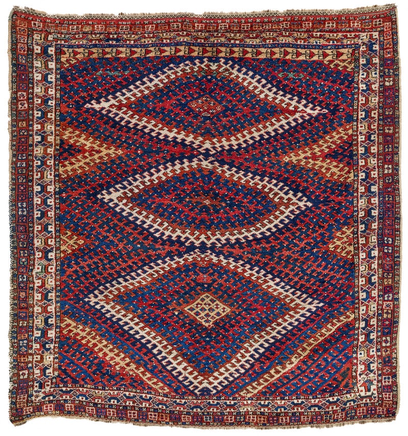 Luri: ca. 1900, 177 x 171 cm, South West Persia, Fars The red field of this rare rug made by a Luri tribal group is completely covered in huge sets of flat nested diamonds. Their hooked outlines interlock