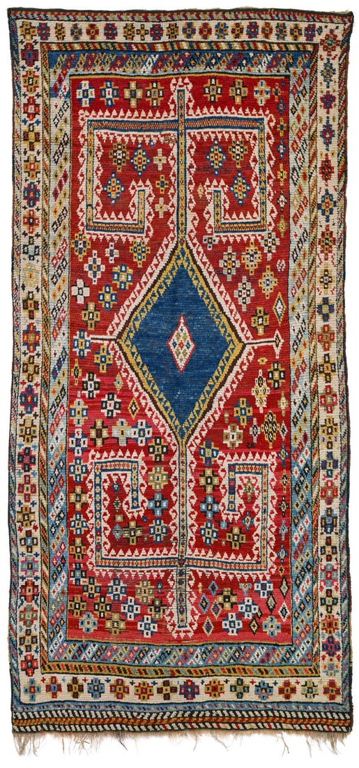 Qashqai Gabbeh: ca. 1900, 293 x 137 cm, South West Persia, Fars A blue diamond with a double hooked outline lies at the centre of the red field. Its vertical points are decorated with huge rectilinear double hooks.