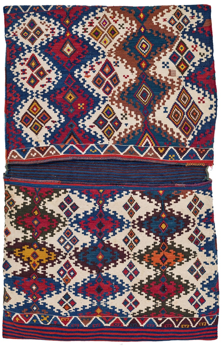 Kurdish Heybe: late 19th century, 145 x 94 cm, Central Anatolia, Cihanbeyli Completely preserved, this kilim double bag was woven by a Kurdish tribal group who used to live in the Marash region before migrating to