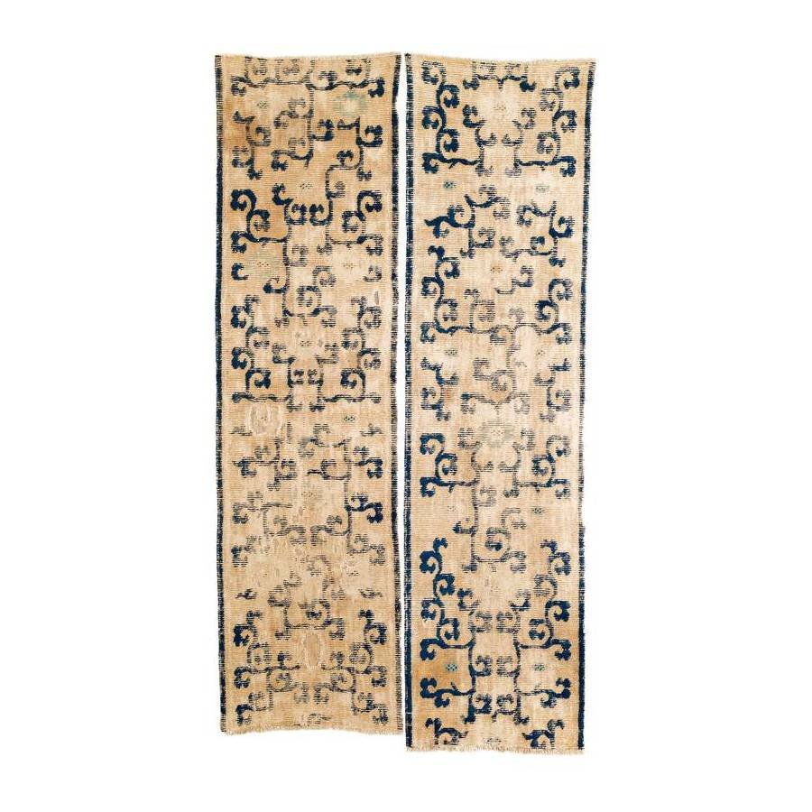 Two Ningxia Bench Runner Fragments: 17th century, a = 227 x 62 cm, b = 232 x 63 cm, West China Two parts of a Ningxia bench runner which has survived in fragmented shape. Rather than being divided into sections, the field shows a contin