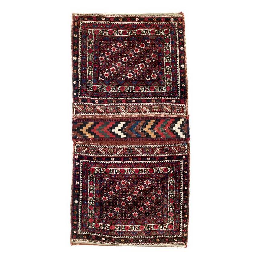 Afshar Khorjin: First quarter 20th century, 137 x 70 cm, South Persia, Kerman region A completely preserved Afshar double bag. The pile-woven faces show a small-format star design on a blue-black ground; the closure 