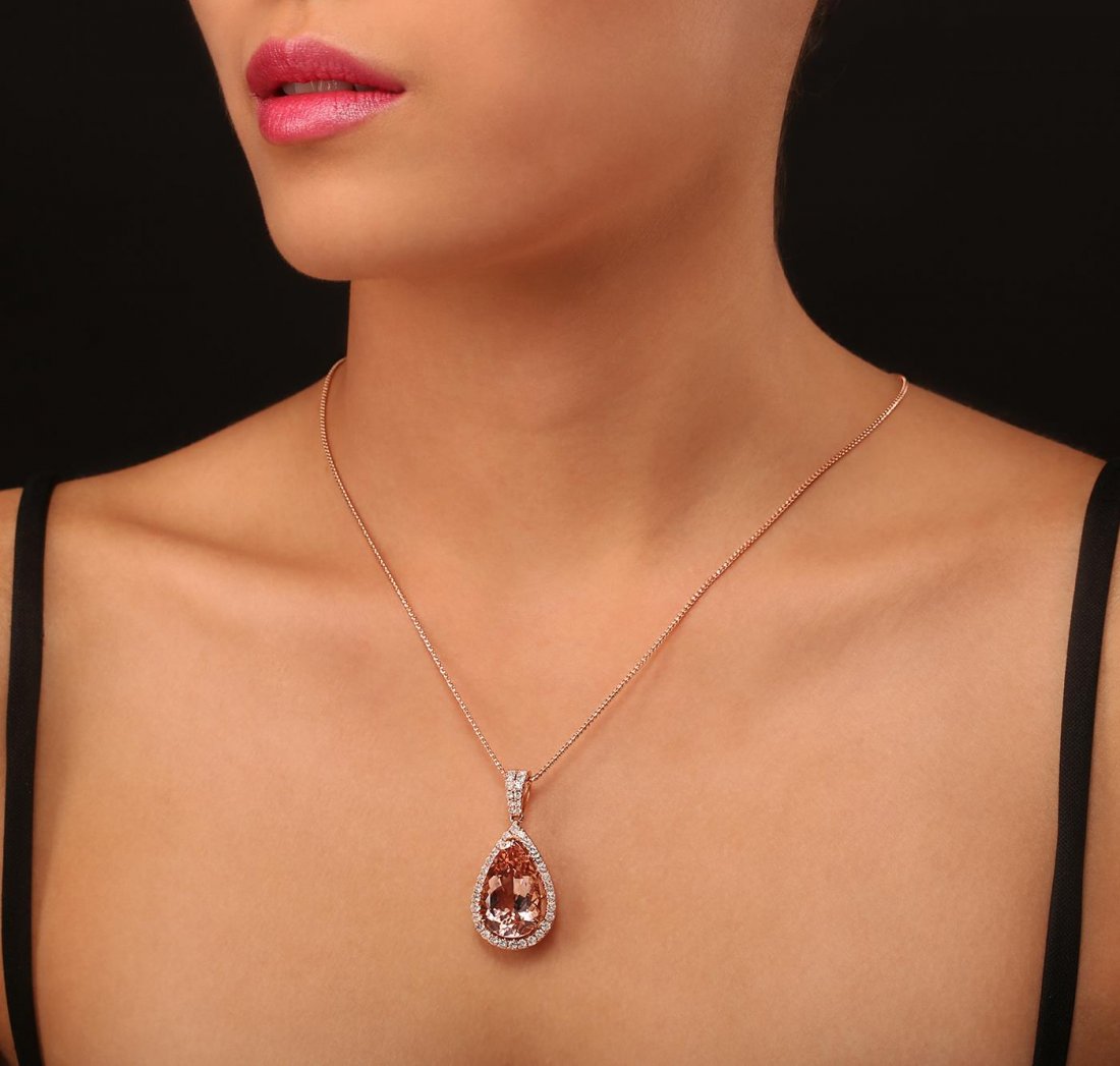 14KT Rose Gold 15.09ct Morganite and Diamond Pendant: One electronically tested 14KT rose gold ladies cast & assembled morganite and diamond pendant with chain. Condition is new, good workmanship. The pendant features a morganite set within a diamond bez