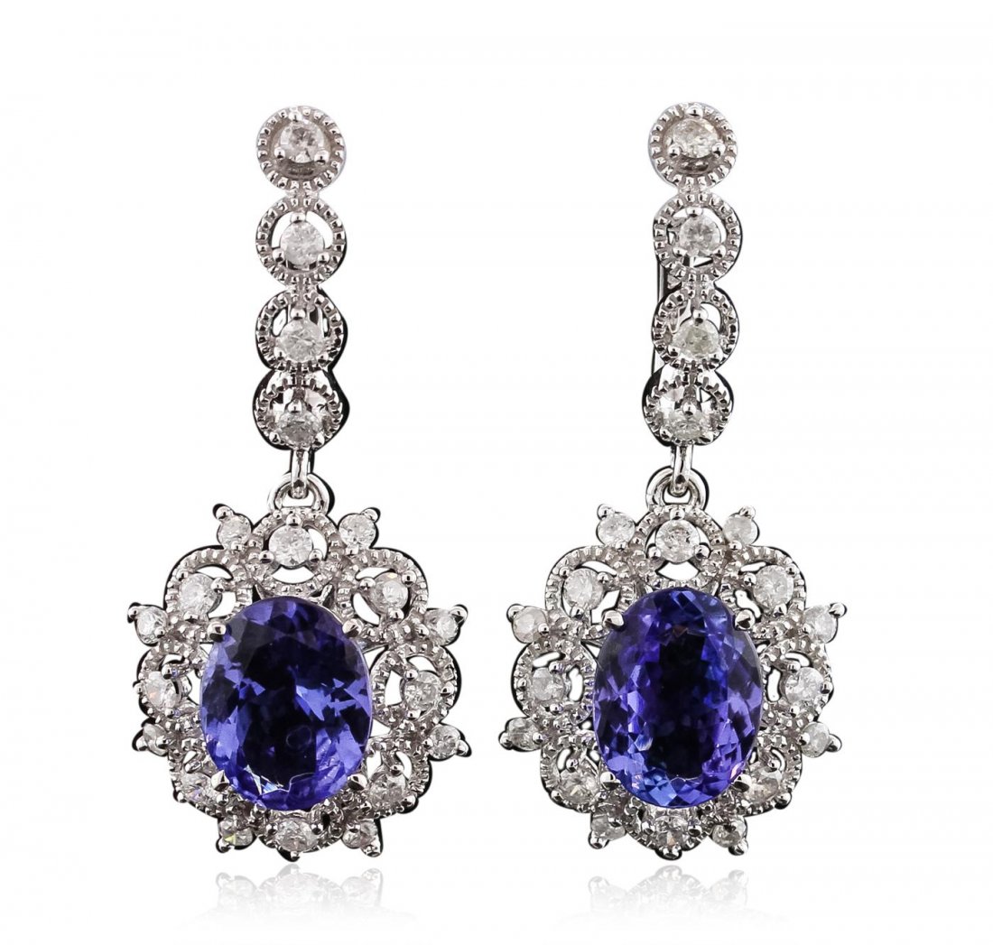 14KT White Gold 4.82ctw Tanzanite and Diamond Earrings: One electronically tested 14KT white gold ladies cast & assembled tanzanite & diamond dangle earrings with hinged, snap locking posts. Each earring features a tanzanite set within a gallery of diamond