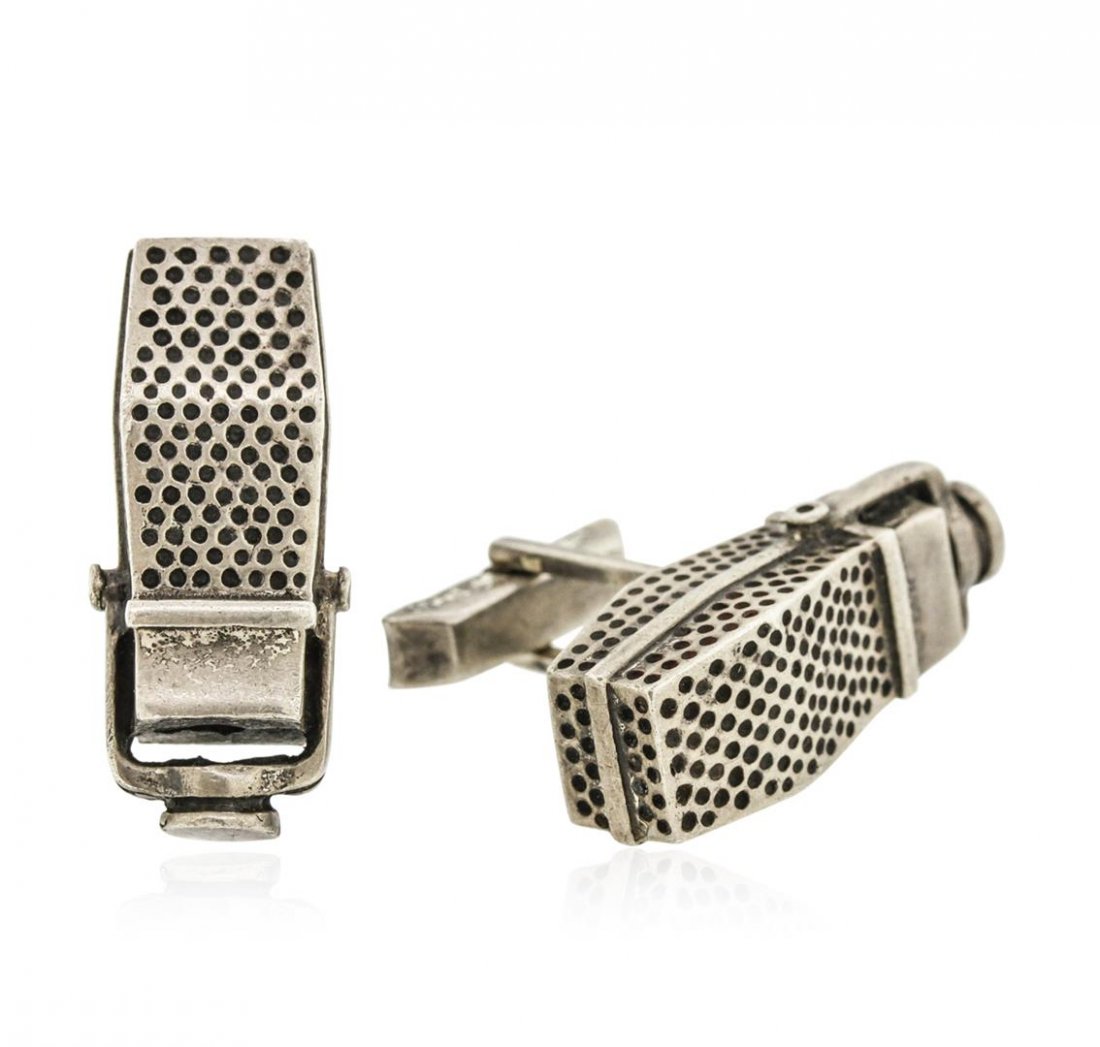 Sterling Silver Cuff Link Set: A set of four cuff links featuring sterling silver. Set 1, Microphone cufflinks by Fenwick and Sailors; Set 2, Slot Machines by Fenwick and Sailors; Set 3, Embossed Lions by Fenwick and Sailors; Set 4
