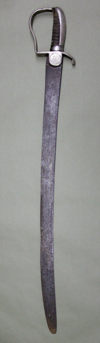 1855 A.D. GERMAN DESIGNED CUBAN SWORD: An authentic German designed sword made for Cuban officers. Etched in the guard of the sword is the year 1855, directly under that are the initials J.M.C., and on the opposite side a flower . There is