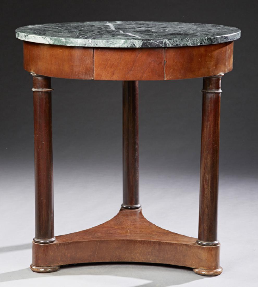 French Empire Style Carved Mahogany Marble Top: French Empire Style Carved Mahogany Marble Top Gueridon, 20th c., the circular verde antico marble over a wide skirt with a small frieze drawer, on cylindrical columnar legs to a tripartite base, H.- 