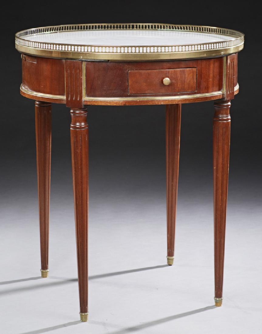 French Carved Mahogany Louis XVI Style Marble Top: French Carved Mahogany Louis XVI Style Marble Top Bouillotte Table, late 19th c., the figured white marble with a pierced gallery over a wide skirt with two frieze drawers and two pull out leather ins