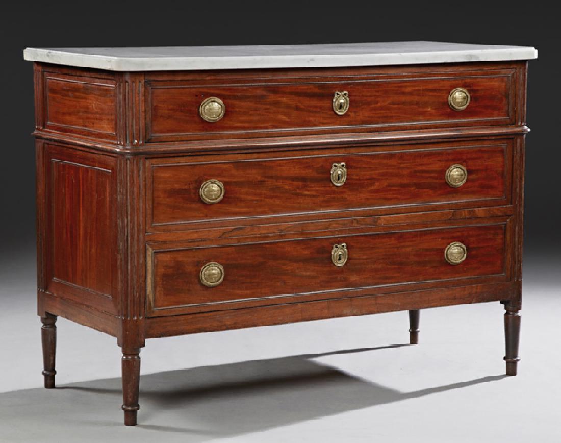 French Louis XVI Style Carved Mahogany Marble Top: French Louis XVI Style Carved Mahogany Marble Top Commode, early 20th c., the ogee edge rounded corner figured white marble over three drawers flanked by pilasters, on tapered cylindrical legs with to