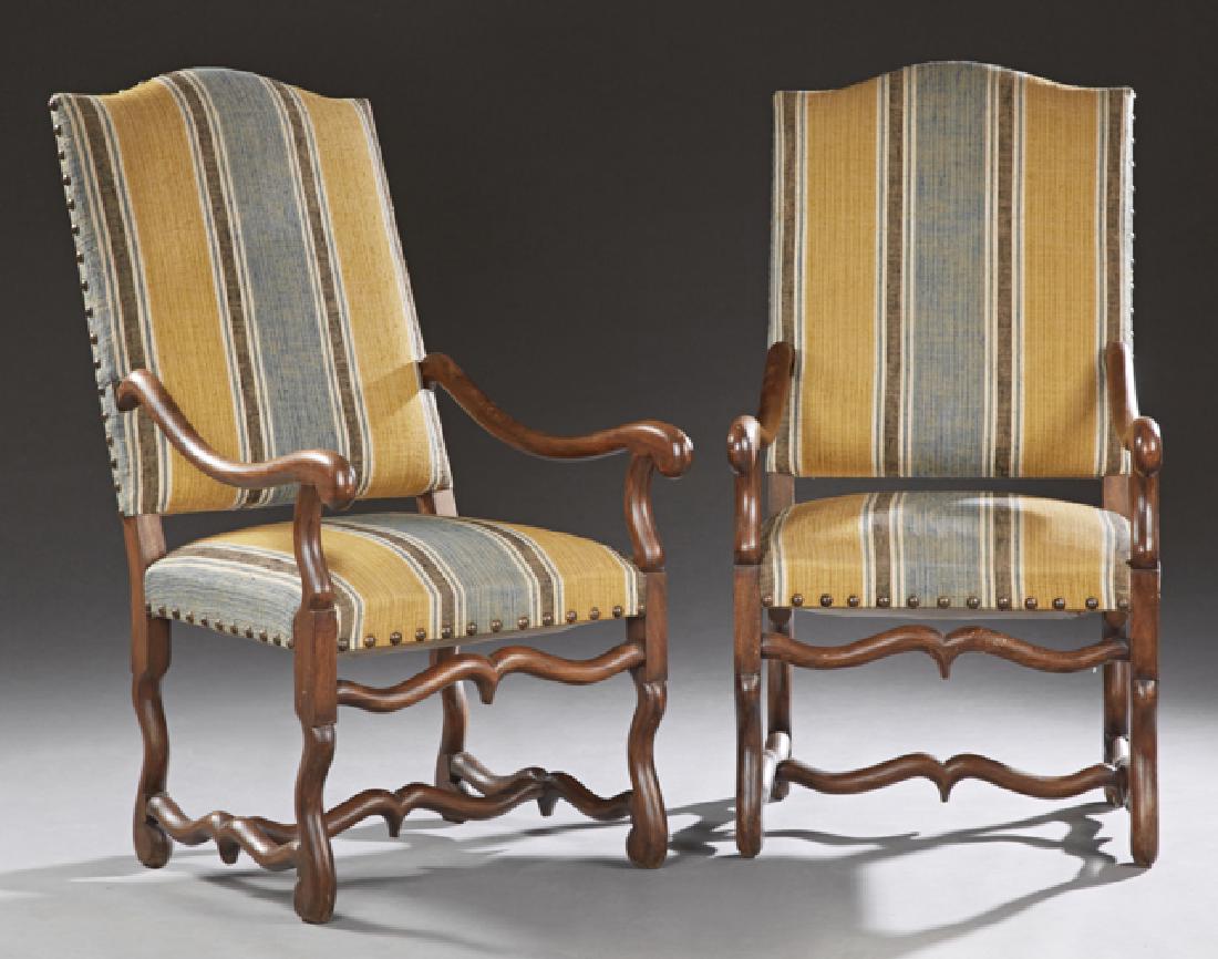 Pair of French Louis XIII Style Carved Beech Fauteuils,: Pair of French Louis XIII Style Carved Beech Fauteuils, 20th c., the arched upholstered backs over scrolled arms and upholstered seats, on cabriole legs joined by serpentine stretchers, in blue and go