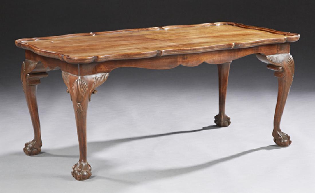 English Carved Walnut Chippendale Style Coffee Table,: English Carved Walnut Chippendale Style Coffee Table, 20th c., the shaped dished top on a serpentine skirt on cabriole legs with ball and claw feet, H.- 17 1/4 in., W.- 38 3/8 in., D.- 20 1/2 in.