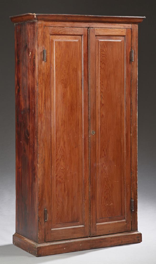 Louisiana Cypress Cupboard, 19th c., the ogee crown,: Louisiana Cypress Cupboard, 19th c., the ogee crown, over long double fielded panel doors, on a stepped plinth base, H.- 74 in., W.- 38 1/2 in., D.- 17 7/8 in.