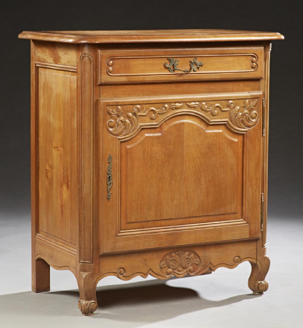 French Louis XV Style Carved Cherry Confiturier, early: French Louis XV Style Carved Cherry Confiturier, early 20th c., the stepped edge rounded corner top over a frieze drawer above a cupboard door with a brass escutcheon and fiche hinges, on cabriole leg