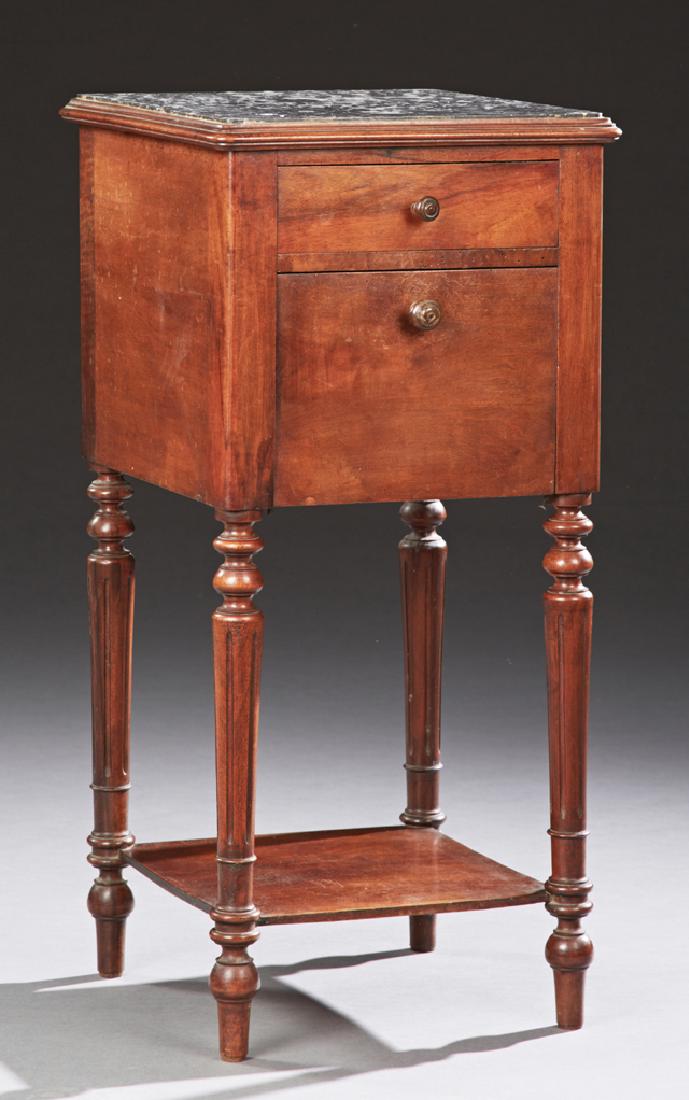 French Louis Philippe Carved Mahogany Marble Top: French Louis Philippe Carved Mahogany Marble Top Nightstand, 19th c., the inset highly figured black marble over a frieze drawer above a ceramic lined fall front pot cupboard, on turned fluted legs wi
