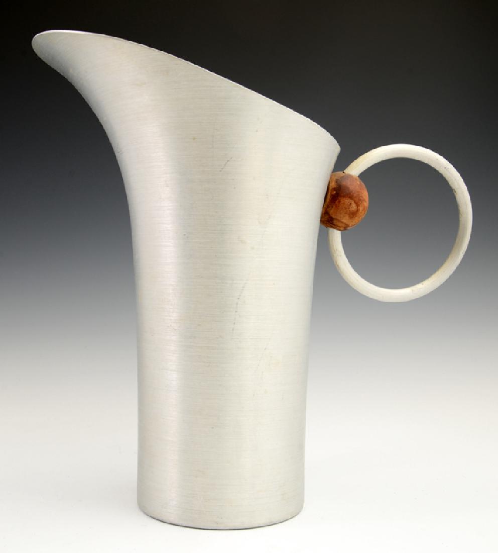 Russel Wright Mid Century Modern Spun Aluminum Pitcher,: Russel Wright Mid Century Modern Spun Aluminum Pitcher, c. 1932, with wooden accents, signed on the bottom, H.- 10 1/8 in., W.- 10 3/4 in., D.- 6 1/8 in.