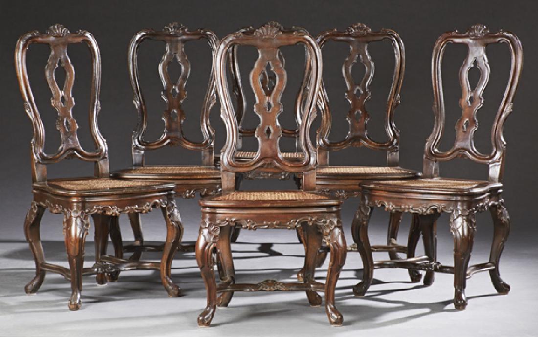 Set of Six Italian Carved Beech Dining Chairs, 20t: Set of Six Italian Carved Beech Dining Chairs, 20th c., the arched shell carved crest rails over pierced splats to bowed caned seats on cabriole legs with shell carved knees to pad feet joined by a sh