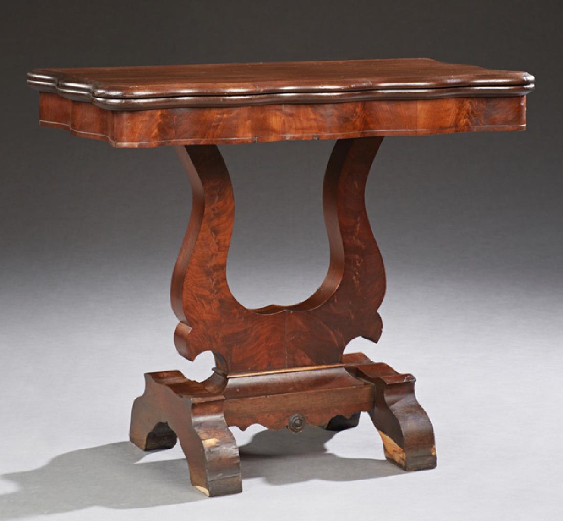American Classic Carved Oak and Mahogany Games Table,: American Classic Carved Oak and Mahogany Games Table, 19th c., the serpentine lift top over a serpentine skirt to a lyre form support to trestle feet, H.- 28 1/8 in., W.- 33 1/4 in., D.- 16 7/8 in., O