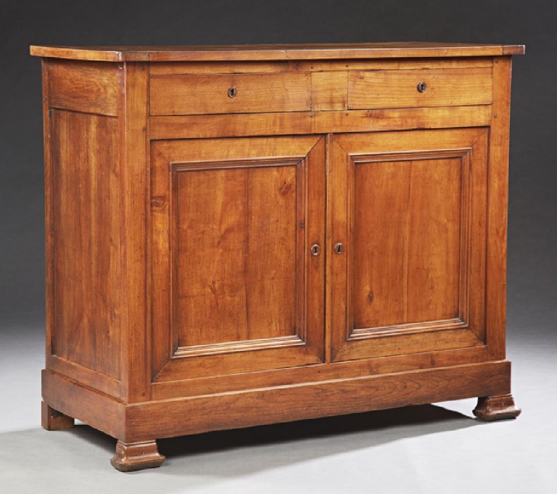 French Louis Philippe Carved Cherry Sideboard, c. 1850,: French Louis Philippe Carved Cherry Sideboard, c. 1850, the rectangular top over two frieze drawers above double cupboard doors on a plinth base, on ogee block feet, H.- 44 in., W.- 52 1/4 in., D.- 23