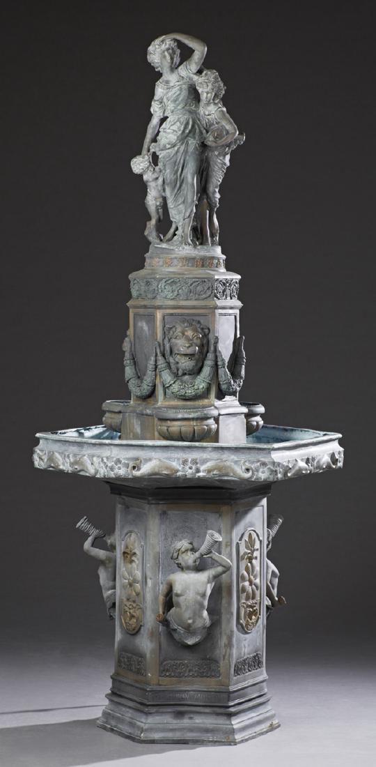Large Patinated Bronze Fountain, 20th c., with a: Large Patinated Bronze Fountain, 20th c., with a surmount of a woman and two children, on a hexagonal socle with relief lions' heads and floral garlands, above a hexagonal bowl, on a hexagonal support