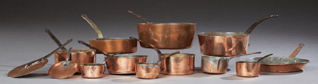 Group of French Copper Cookware, early 20th c.,: Group of French Copper Cookware, early 20th c., consisting of 10 graduated sauce pans with iron handles, two lids with iron handles and a frying pan with an iron handle, (13 Pcs). Largest: H.- 7 in., 