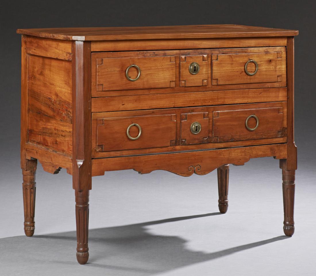 French Louis XVI Style Carved Walnut Commode, 19th: French Louis XVI Style Carved Walnut Commode, 19th c., the canted corner rectangular top over two deep drawers and a serpentine skirt, on tapered reeded legs, H.- 32 7/8 in., W.- 40 3/4 in., D.- 22 in