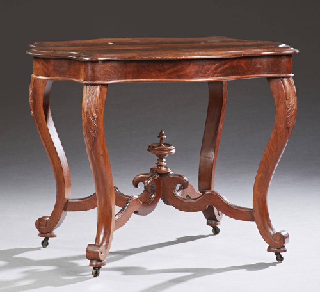 American Carved Mahogany Tortoise Top Center: American Carved Mahogany Tortoise Top Center Table, 19th c., the ogee edge figured top over a wide skirt on cabriole legs with scrolled toes, joined by a serpentine X-form stretcher with a central tur