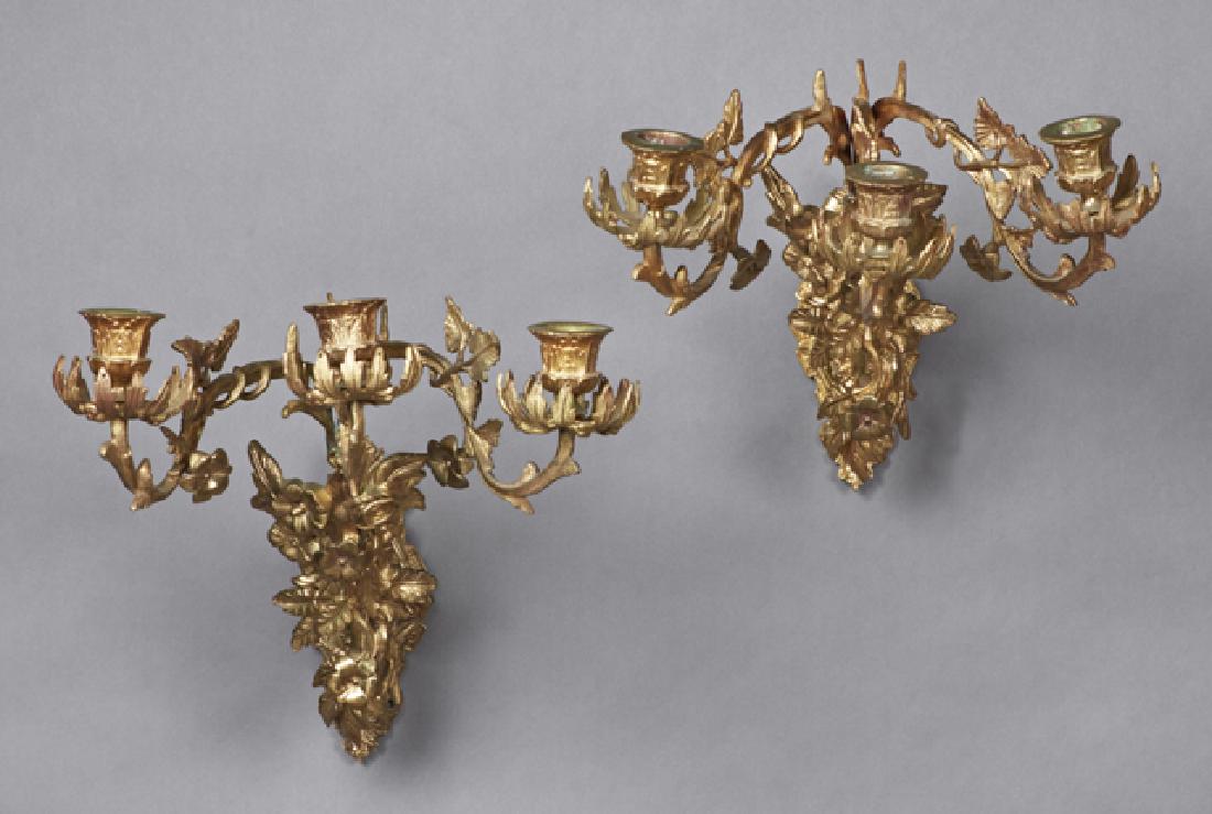 Pair of Aesthetic Style Three Light Sconces, 20th: Pair of Aesthetic Style Three Light Sconces, 20th c., the relief back plates issuing scrolled floral relief decorated arms upholding three leaf decorated candle arms, not electrified, H.- 17 1/2 in.,