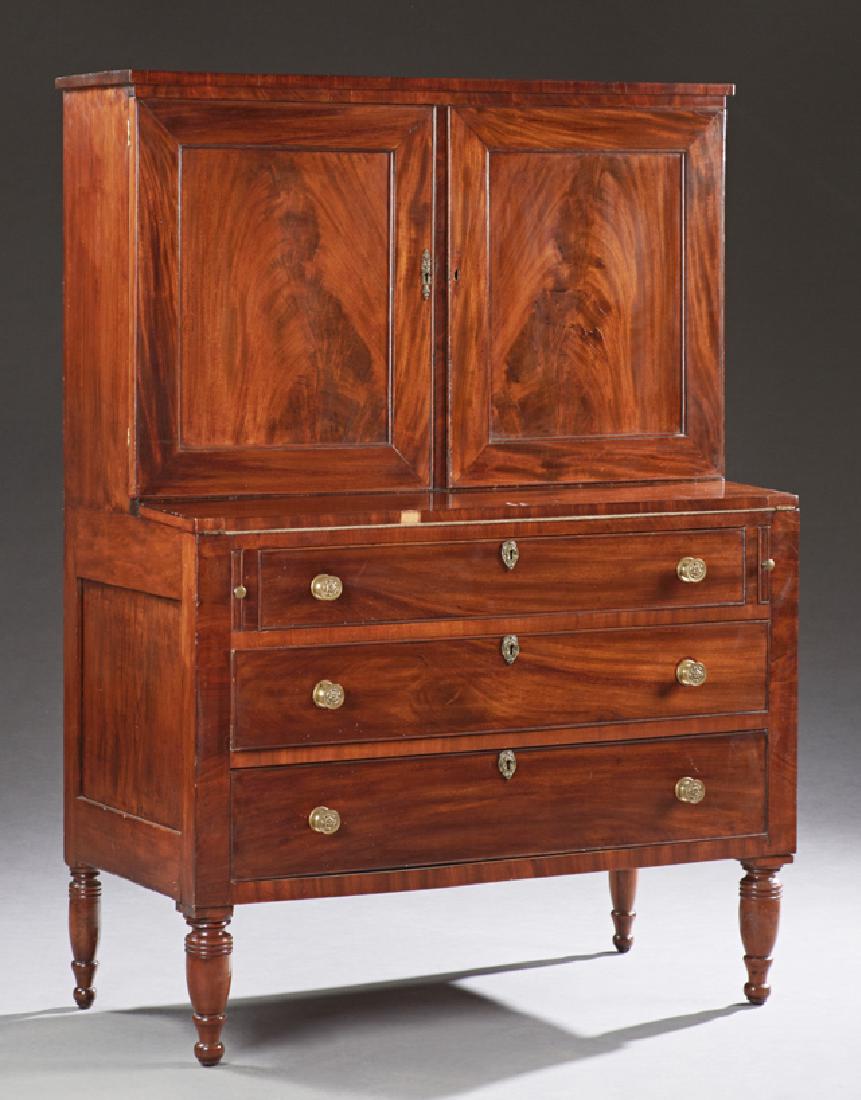 American Federal Carved Mahogany Butler's Secretary,: American Federal Carved Mahogany Butler's Secretary, 19th c., the double paneled cupboard doors over a fold out navy leather gilt tooled writing surface, above three deep drawers, on ring turned legs,
