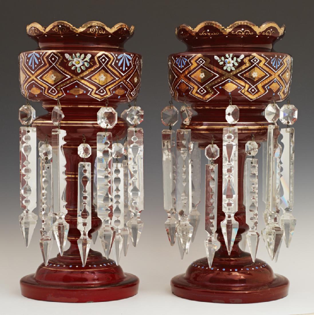 Pair of English Victorian Ruby Glass Lusters, 19th c.,: Pair of English Victorian Ruby Glass Lusters, 19th c., gilt and enamel decoration, hung with spear and button prisms, H.- 14 in., Dia.- 6 1/4 in.