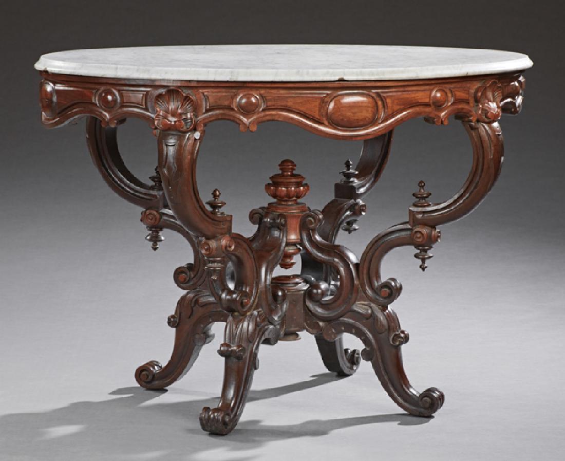 American Carved Mahogany Marble Top Center Table, c.: American Carved Mahogany Marble Top Center Table, c. 1870, the oval ogee edge figured white marble on a base with a shell and scroll carved serpentine skirt, on four double C-scroll supports, joined b