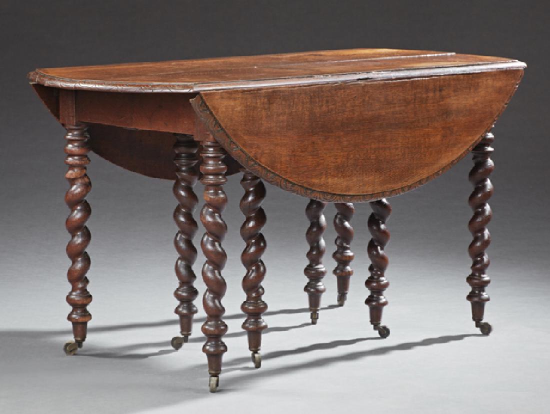 French Louis XIII Style Carved Oak Drop Leaf Table 19th: French Louis XIII Style Carved Oak Drop Leaf Table 19th c., the oval top opening to accept leaves, over a wide skirt, on eight barley twist legs, with toupie feet, H.- 28 1/4 in., W.- Closed- 23 3/4 i