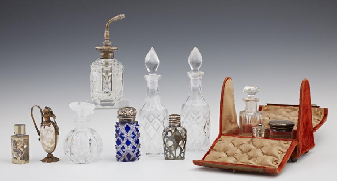 Group of Eleven Dressing Table Accessories, consisting: Group of Eleven Dressing Table Accessories, consisting of a shell form souvenir perfume bottle; a sterling top cut glass atomizer; 2 pressed glass perfume bottles with stoppers; a Lalique style crysta
