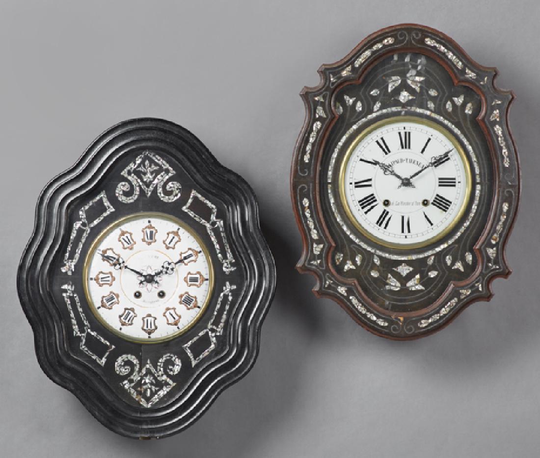 Two French Ebonized Pine Mother-of-Pearl Inlaid Wall: Two French Ebonized Pine Mother-of-Pearl Inlaid Wall Clocks, c. 1870, time and strike, with shaped undulating cases, one with a porcelain face with porcelain chapter marks; the second with a maker's n