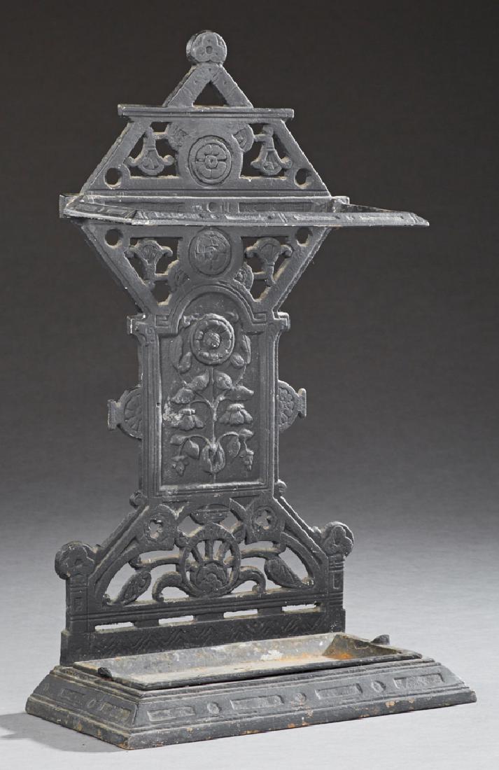 American Cast Iron Umbrella Stand, late 19th c., with a: American Cast Iron Umbrella Stand, late 19th c., with a pierced relief floral decorated back over a removable drip pan, H.- 27 1/2 in., W.- 15 1/2 in., D.- 7 1/2 in.
