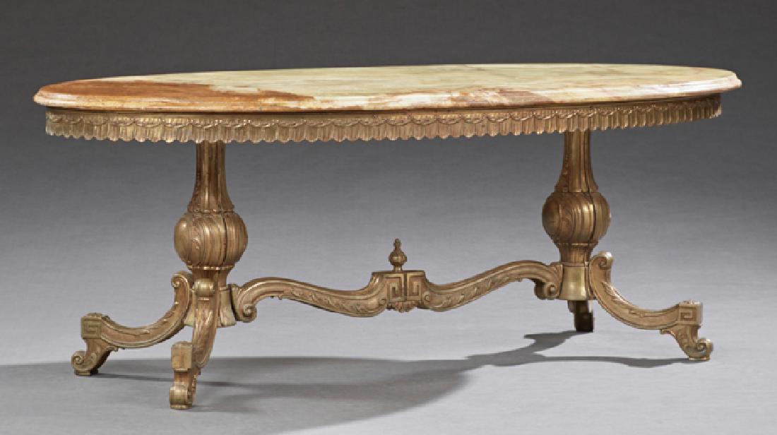 French Brass and Onyx Louis XV Style Coffee Table, 20th: French Brass and Onyx Louis XV Style Coffee Table, 20th c., the oval rounded edge figured onyx on a base with a scalloped skirt, on urn form trestle supports joined by an arched stretcher, H.- 18 1/2 