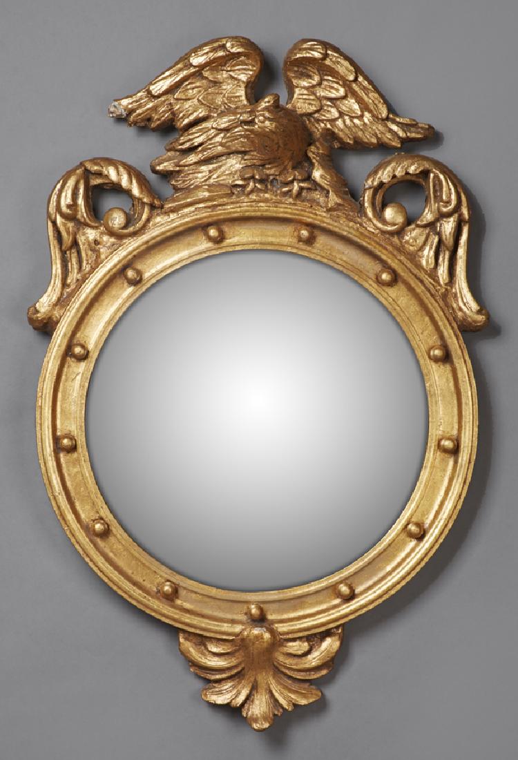 Federal Style Gilt and Gesso Convex Bullseye Mirror, 20: Federal Style Gilt and Gesso Convex Bullseye Mirror, 20th c., with a spread eagle surmount flanked by pierced relief leaves, over a mirror plate flanked by applied orbs, H.- 35 in., W.- 24 in., D.- 5 