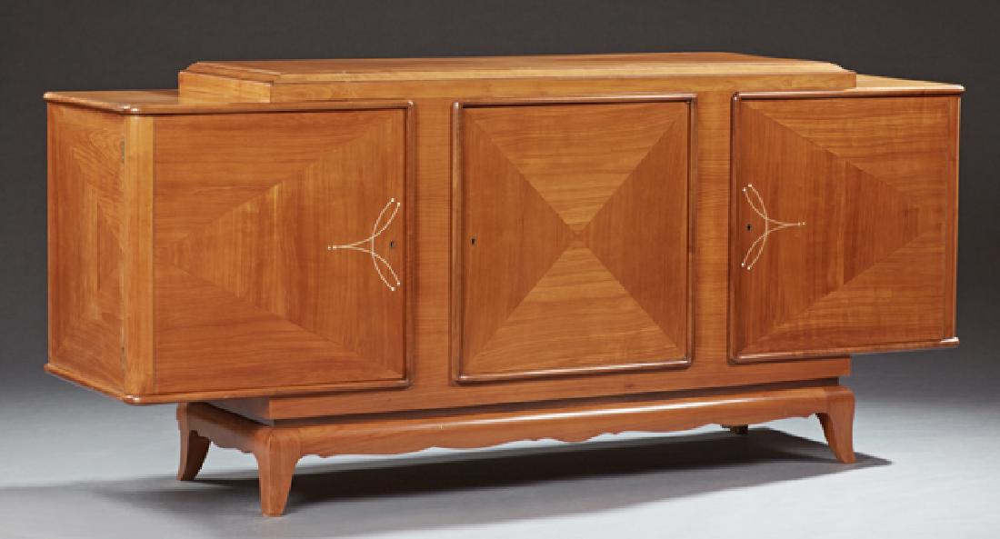 French Carved Cherry Art Deco Louis XVI Style: French Carved Cherry Art Deco Louis XVI Style Sideboard, c. 1920, the raised parquetry inlaid ogee edge center section, over a like inlaid cupboard door, flanked by two bone inlaid cupboard doors, on 