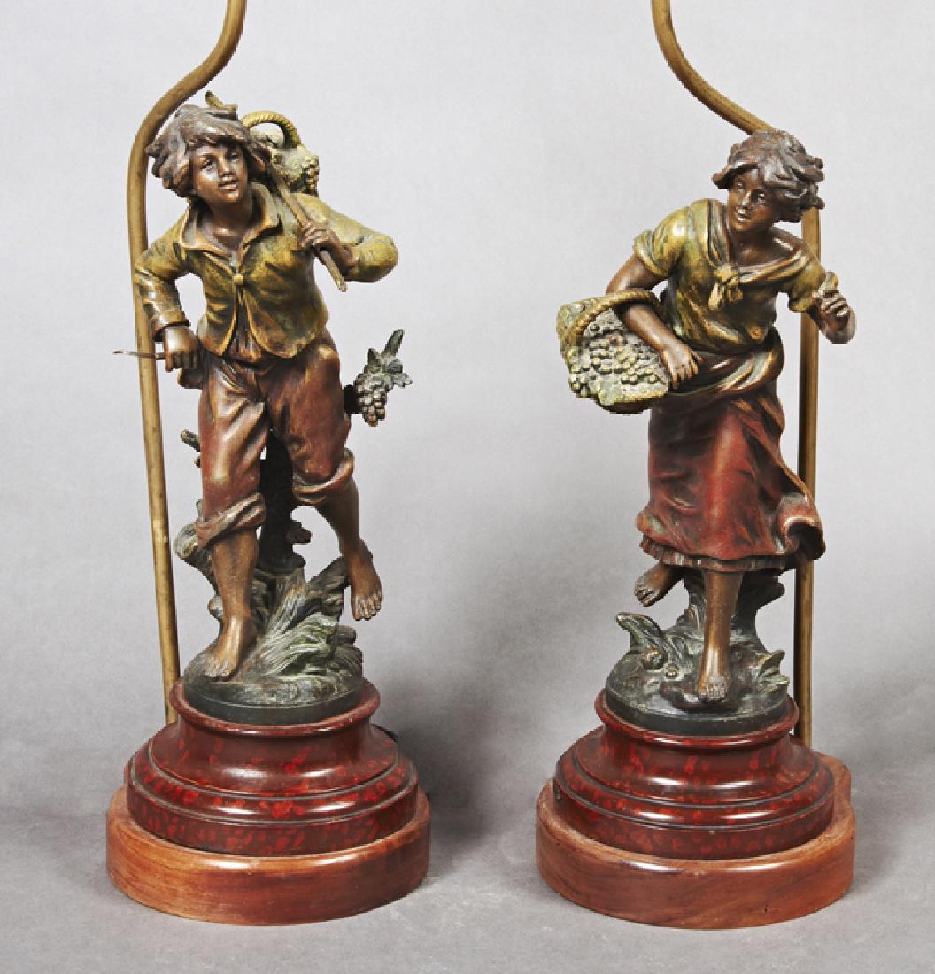 After Louis Moreau (1855-1919), "Vendangeuse," and: After Louis Moreau (1855-1919), "Vendangeuse," and "Vendangeur," early 20th c., pair of patinated spelter figures on stepped turned faux marble wooden bases, now mounted as lamps, H.- 18 in., W.- 7 in