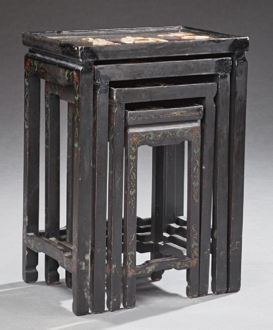 Set of Four Chinoiserie Style Black Lacquer Nesting: Set of Four Chinoiserie Style Black Lacquer Nesting Tables, 20th c., each with a dished top with bone and marble inlay of a Chinoiserie scene, on block legs joined by three-quarter stretchers, Largest