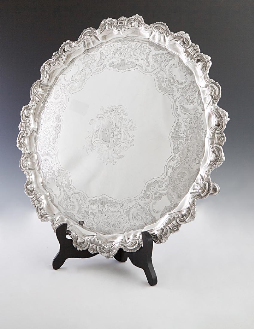 English George III Sterling Silver Salver Tray, 1781,: English George III Sterling Silver Salver Tray, 1781, London, by Richard Brown, with a scalloped relief decorated rim around an engraved border and a central reserve of a coat-of-arms, on tripodal pad